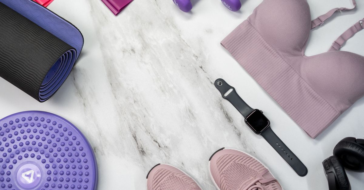 Flat lay of girls' activewear: sports bra, leggings, shoes and a mat