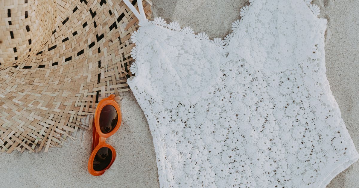 Tween swimwear, sun hat and sunglasses on sand